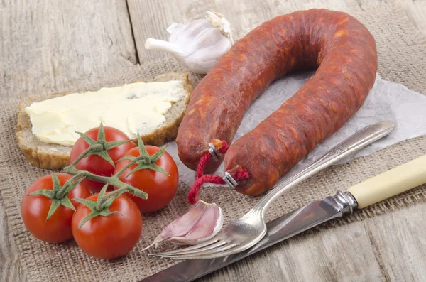 Spanish chorizo on white paper — Stock Photo, Image