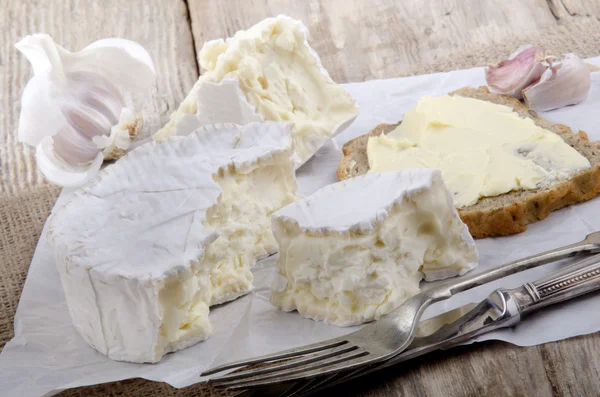 French camembert on white paper — Stock Photo, Image