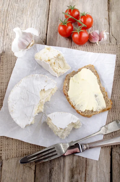 French camembert on white paper — Stock Photo, Image