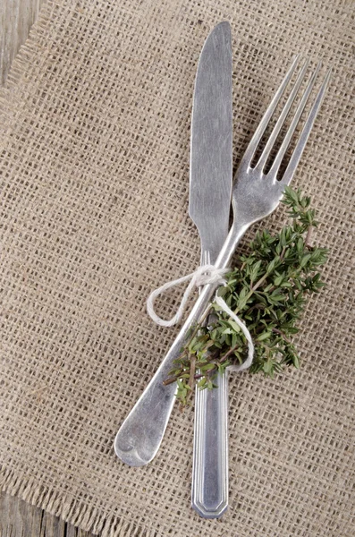 Fork and knife with thyme — Stock Photo, Image