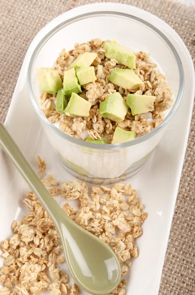 Yogurt with avocado piece and cereals — Stock Photo, Image