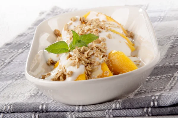 Yogurt with mango piece and cereals — Stock Photo, Image