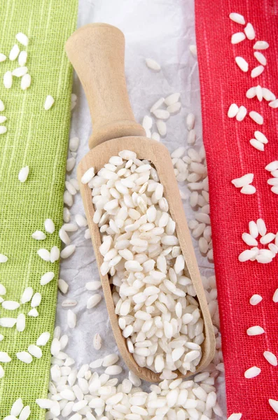 Risotto rice on a wooden shovel — Stock Photo, Image