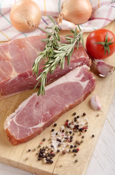 Back bacon with spice on wooden board — Stock Photo, Image