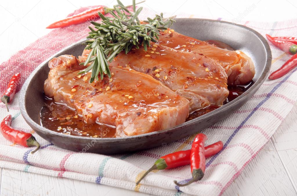 marinated pork chops in a pan