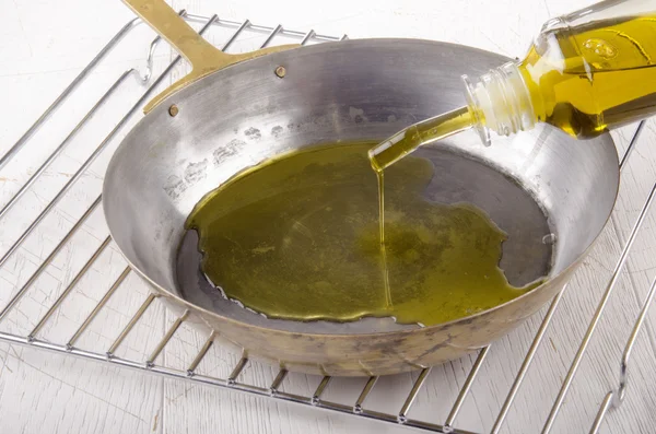 Olive oil is poured into a pan — Stock Photo, Image