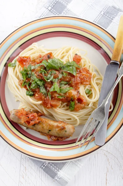 Spaghetti with sausage and tomato — Stock Photo, Image