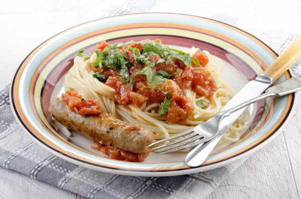 Spaghetti with sausage and tomato — Stock Photo, Image