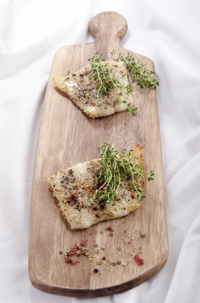 Grilled cod on a wooden board — Stock Photo, Image