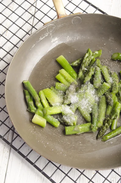 Cooked asparagus in a pan with sugar — Stock Photo, Image
