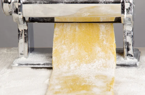 Pasta dough is being processed — Stock Photo, Image