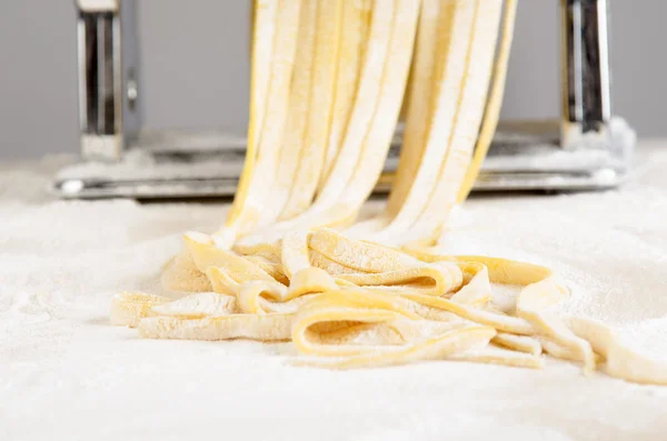 Pasta dough is being processed — Stock Photo, Image