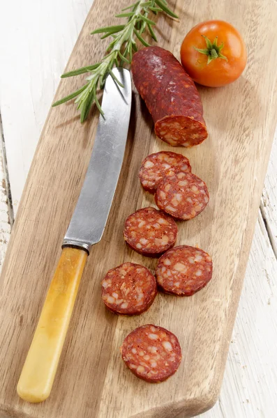 Sliced spanish chorizo, tomato and rosemary — Stock Photo, Image