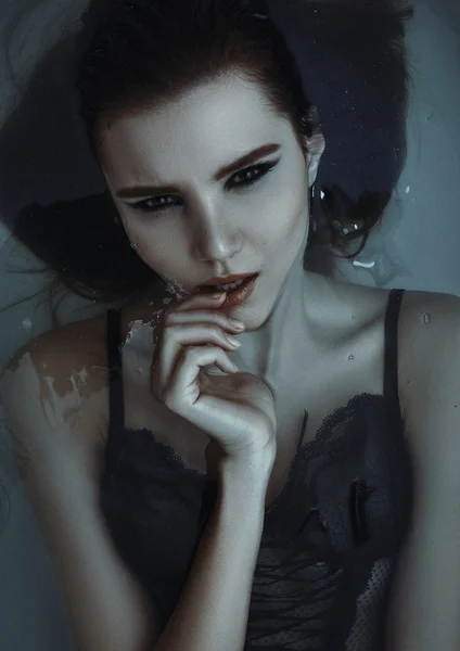 Sexig tjej med mörkt hår i underkläder ligga i badet — Stockfoto
