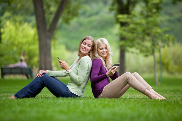 Women With Cellphones In Park