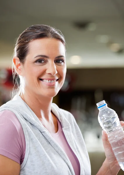 Woman Holding Bottle Of Water At Health Club Royalty Free Stock Photos