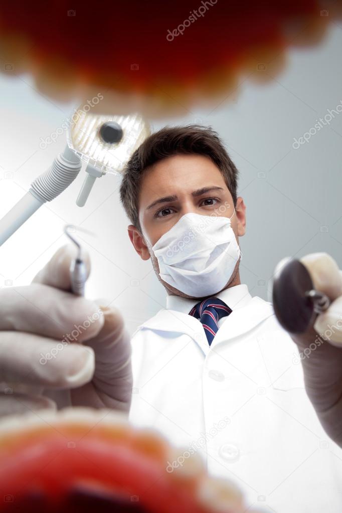 Dentist Examining Patient's Mouth