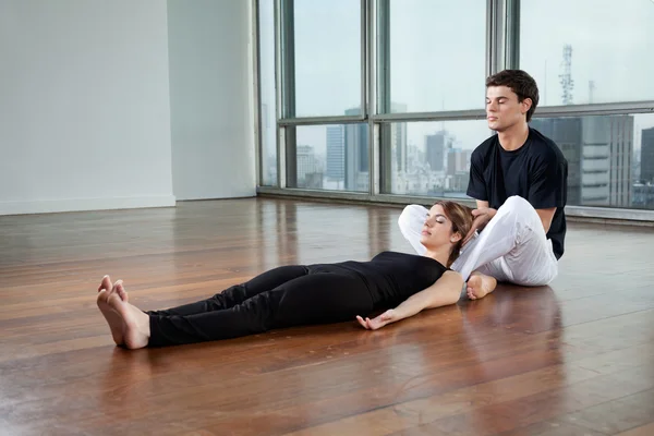 Instrutor ajudando a mulher no exercício de Yoga — Fotografia de Stock