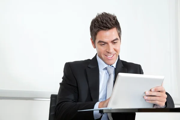 Young Businessman Using Digital Tablet In Office Royalty Free Stock Photos