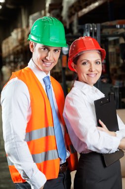 Confident Young Supervisors At Warehouse clipart