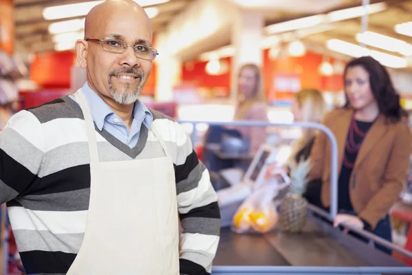 Negozio di alimentari cassiere in piedi al banco Checkout — Foto Stock