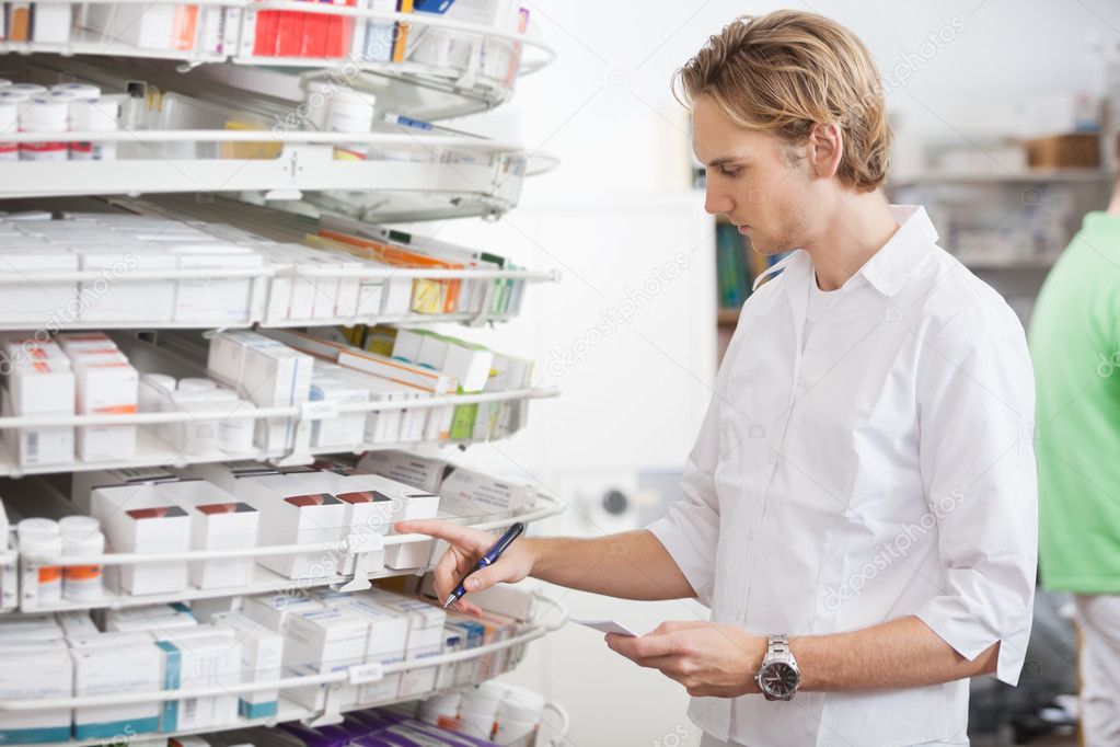 Male Pharmacist Filling Prescription