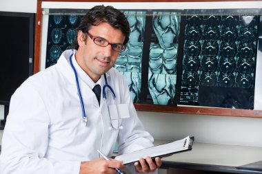 Radiologist At Desk With Clipboard clipart