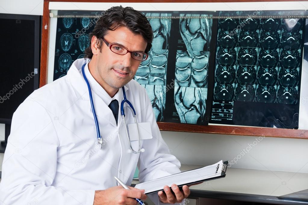 Radiologist At Desk With Clipboard