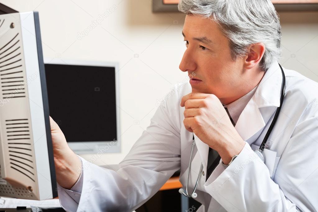 Doctor Looking At Computer Screen