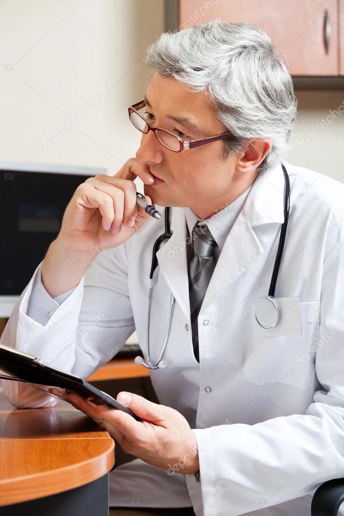 Thoughtful Doctor At Desk
