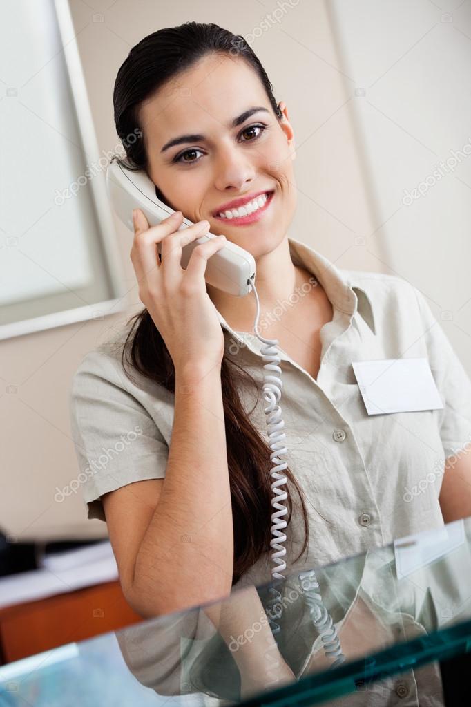 Female Receptionist Answering Call — Stock Photo © SimpleFoto 18551525