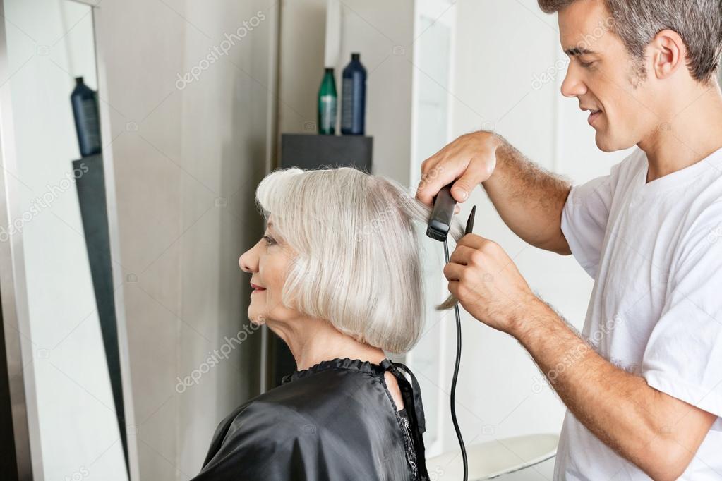 Hairstylist Straightening Customer's Hair