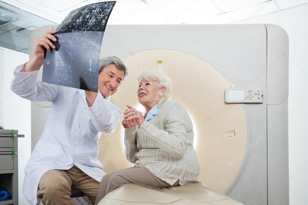 Radiologist With Patient Looking At CT Scan Results — Stock Photo