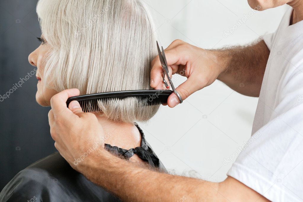 Hairstylist Measuring Hair Length Before Haircut