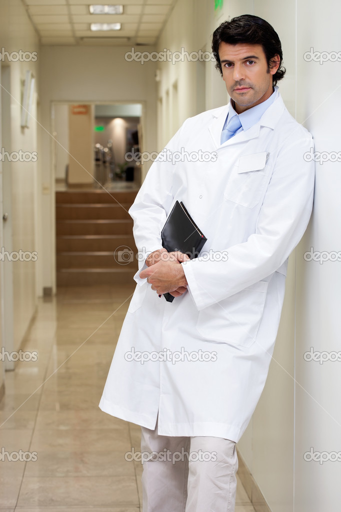 Serious Male Doctor Holding Book