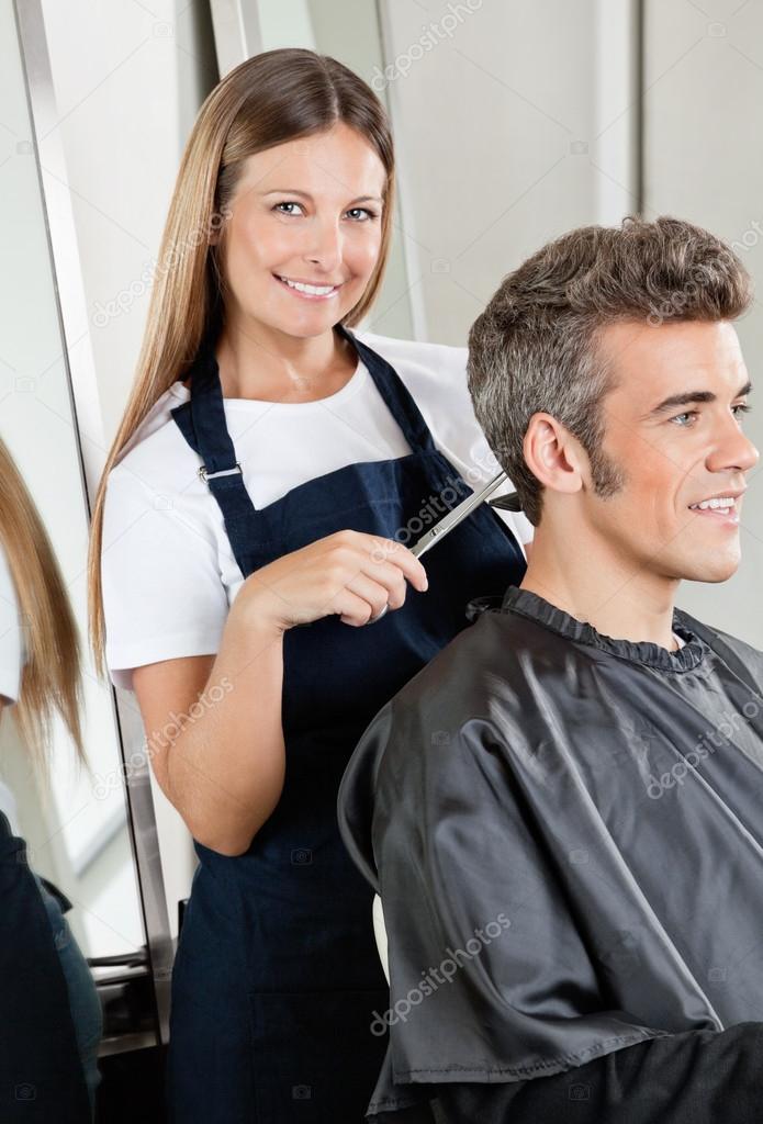 Hairdresser Cutting Client's Hair In Salon
