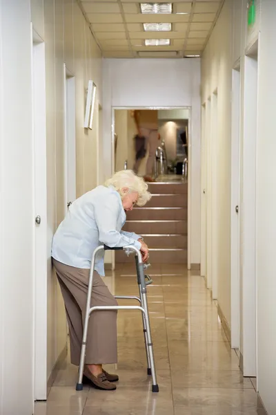 Elderly Woman Standing In Passageway — Stock Photo, Image