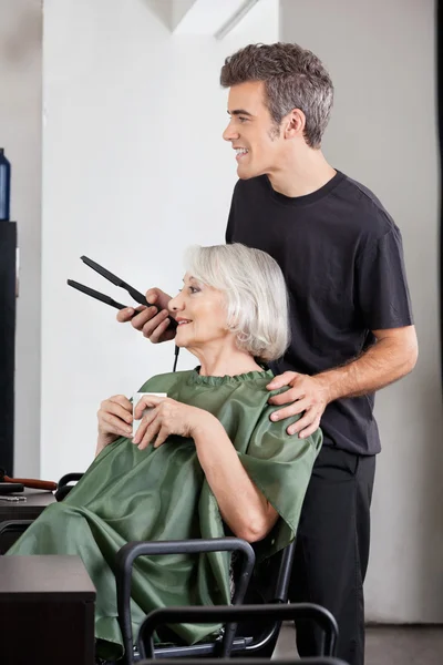 Woman With Coffee Cup And Hairdresser Holding Straightener — Stock Photo, Image