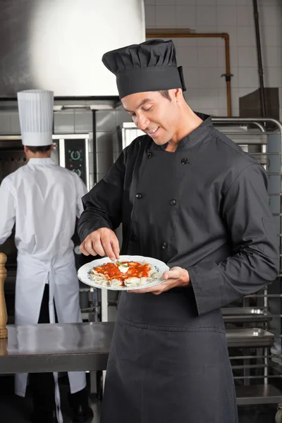 Chef Garnishing Dish In Kitchen — Stock Photo, Image