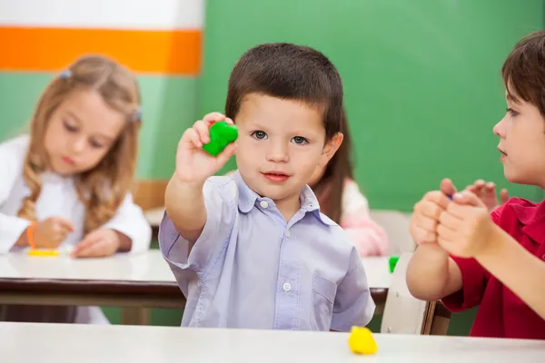 Boy Showing Clay At Classroom — Stock Photo, Image