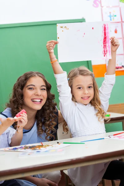 Teacher With Girl Showing Drawing At Desk — Stock Photo, Image
