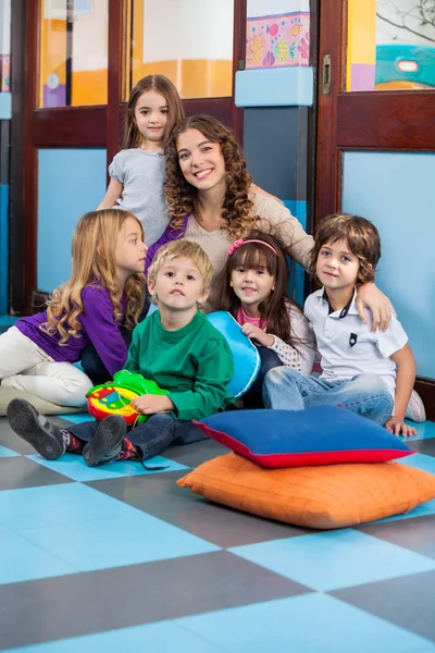 Insegnante e studenti seduti al piano in aula — Foto Stock