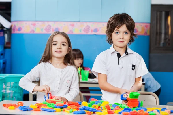 Cute Friends Playing With Blocks At Desk In Kindergarten — Stock Photo, Image