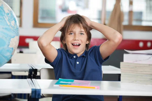 Shocked Little Boy With Globe And Books At Desk — Stock Photo, Image