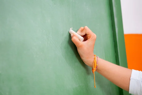 Girl's Hand Writing On Green Chalkboard In Kindergarten — Stock Photo, Image