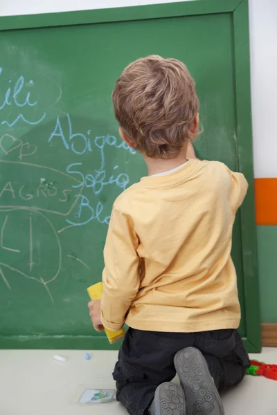 Băiat Writing Pe Chalkboard La Grădiniță — Fotografie, imagine de stoc