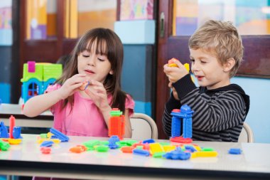 Children Playing With Blocks In Classroom