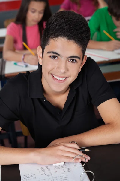 High School Student Smiling While Sitting At Desk Royalty Free Stock Photos