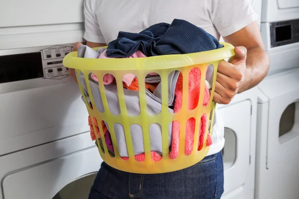 Man Carrying Laundry Basket Stock Image