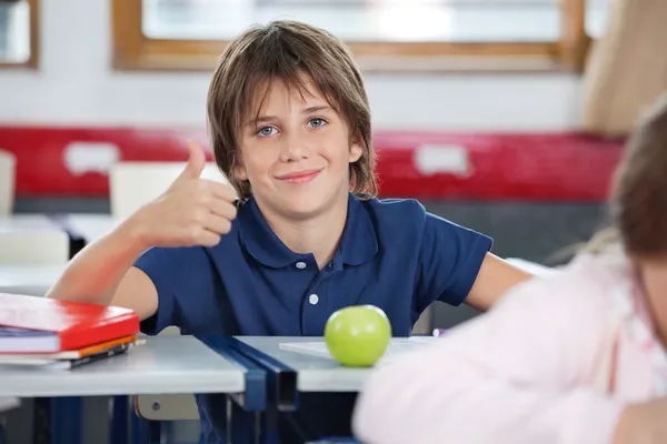 Garçon Gesturing pouces en haut dans la salle de classe — Photo